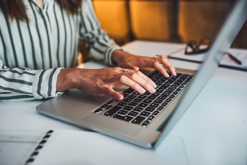 A person is typing on their computer at their desk at work. Rebecca says that asking for accommodati...