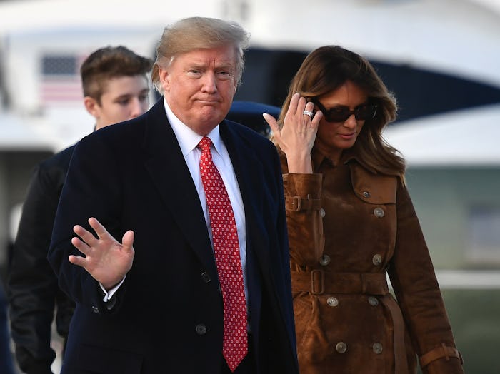 Melania Trump and Donald Trump walking on Thanksgiving, Donald is waving to the camera as Melania lo...