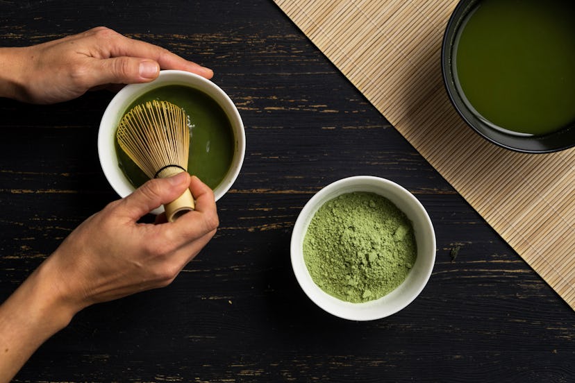 Matcha is whisked into water using a traditional whisk. Matcha, or powdered green tea, has a much hi...