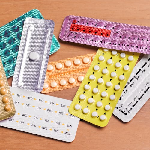 A pile of birth control pill packages in different colors