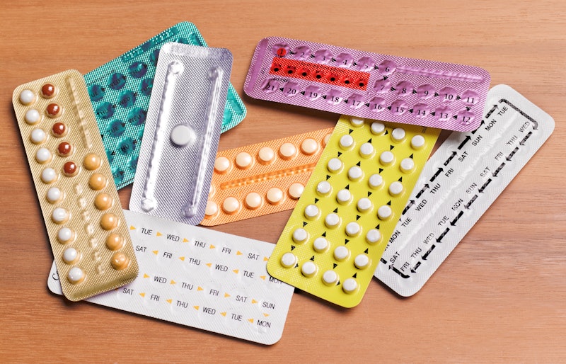 A pile of birth control pill packages in different colors
