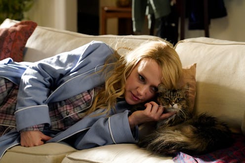 Kate McKinnon pets a cat during a Saturday Night Live sketch