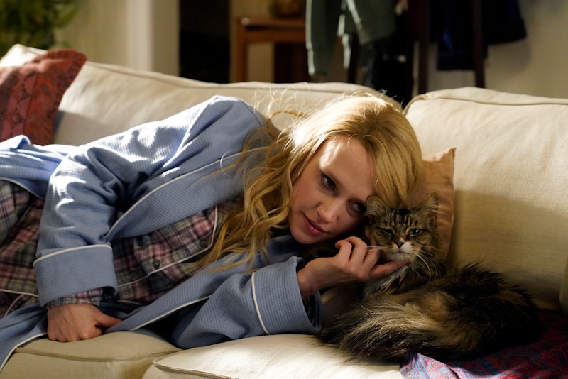 Kate McKinnon pets a cat during a Saturday Night Live sketch
