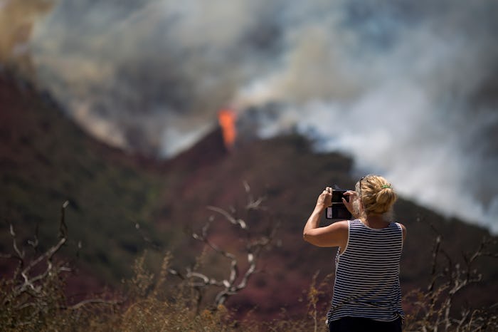 woman taking a picture of the California wildfires