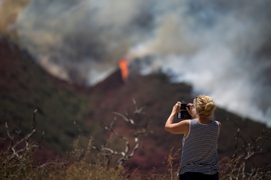 woman taking a picture of the California wildfires