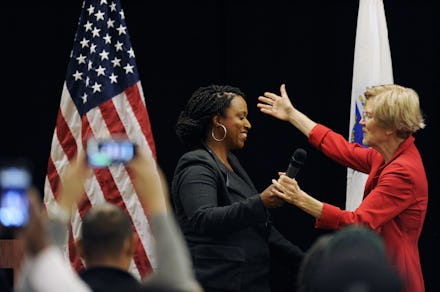 Rep. Ayanna Pressley holding hands and about to embrace Elizabeth Warren