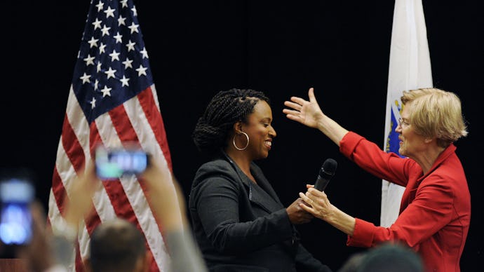 Rep. Ayanna Pressley holding hands and about to embrace Elizabeth Warren
