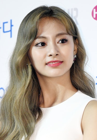 Tzuyu steps out in a white dress for a red carpet event.