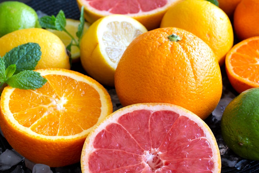Citrus fruits including oranges and grapefruit are shown on ice. Sources of vitamin C including citr...