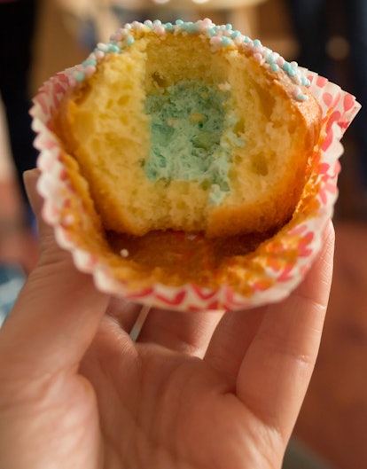 A cupcake with blue icing that is part of a gender reveal