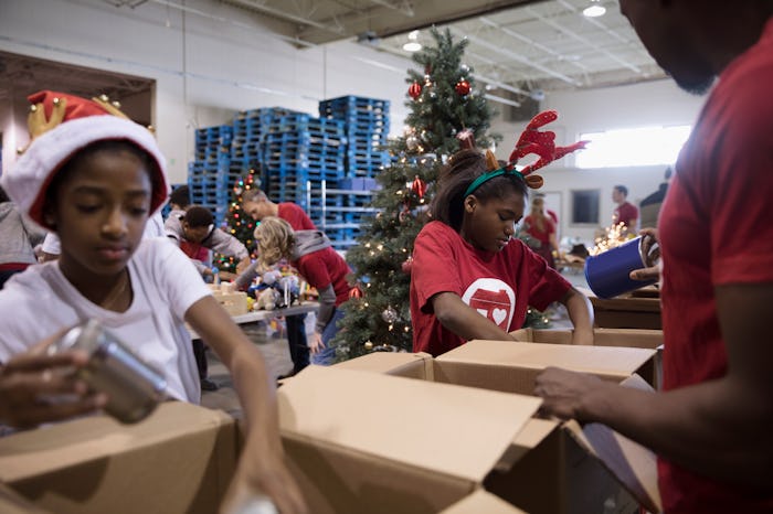 kids volunteering for Christmas in santa hats
