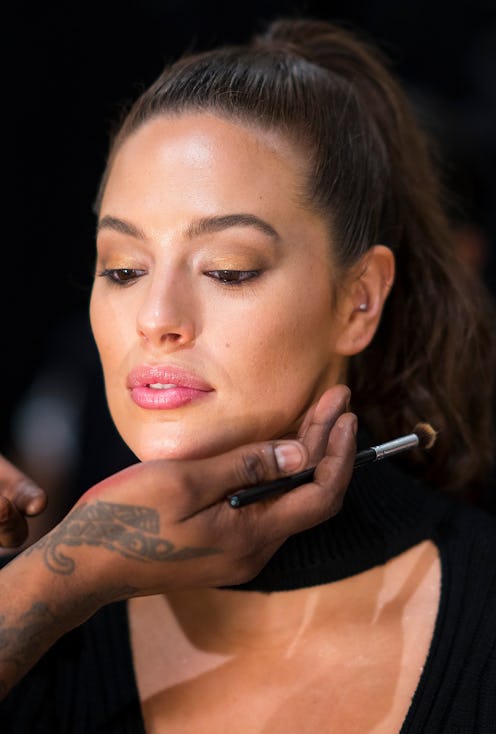 A makeup artist styling a woman with dry skin