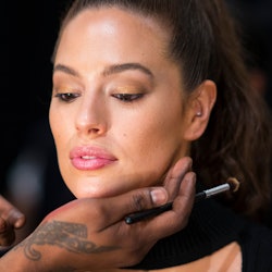 A makeup artist styling a woman with dry skin