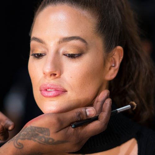 A makeup artist styling a woman with dry skin