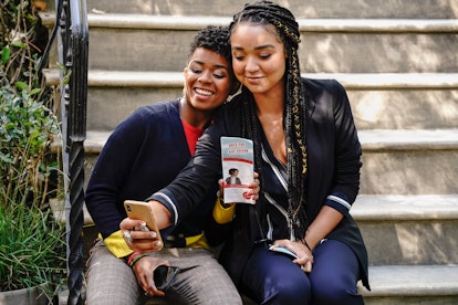 Kat and her campaign manager Tia sit on a porch while taking a selfie on the show The Bold Type. Que...