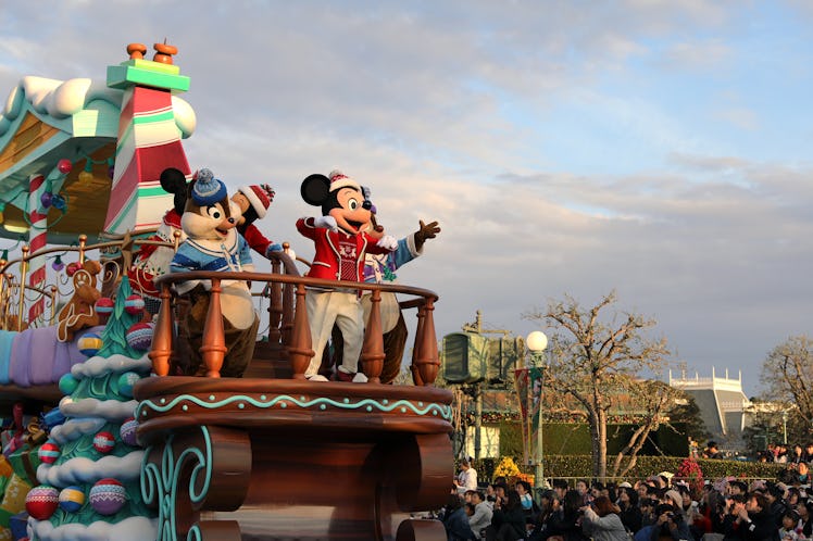 Mickey Mouse and other Disney characters pose on float in Magic Kingdom during a Christmas celebrati...