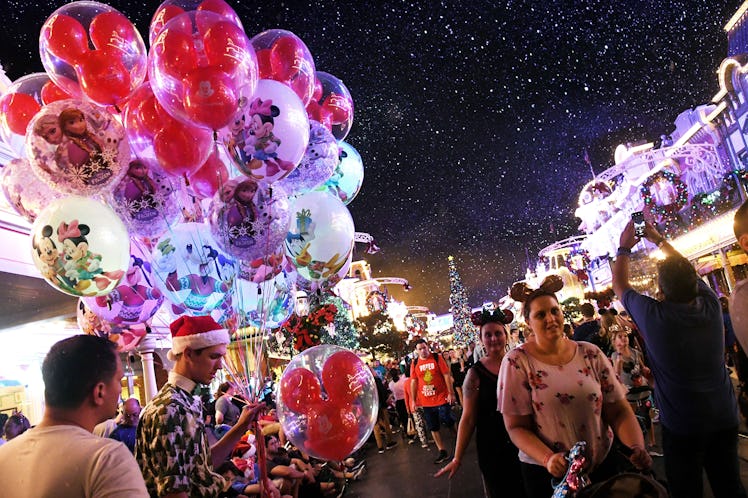Disney lovers walk down a crowded Main Street during Mickey's Very Merry Christmas Party.
