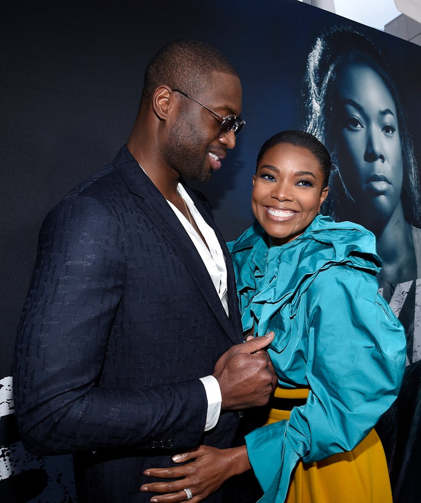Gabrielle Union & Dwyane Wade hugging and posing at a red carpet event