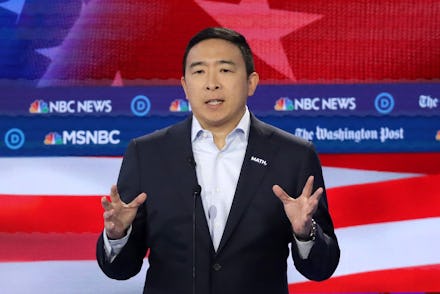 Andrew Yang talking on msnbc in front of a graphic of the american flag