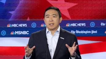 Andrew Yang talking on msnbc in front of a graphic of the american flag