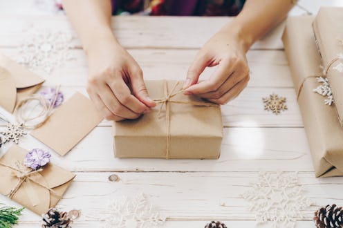 A woman wraps gifts for the holidays. Holiday food can trigger diet and exercise talk, but it doesn'...