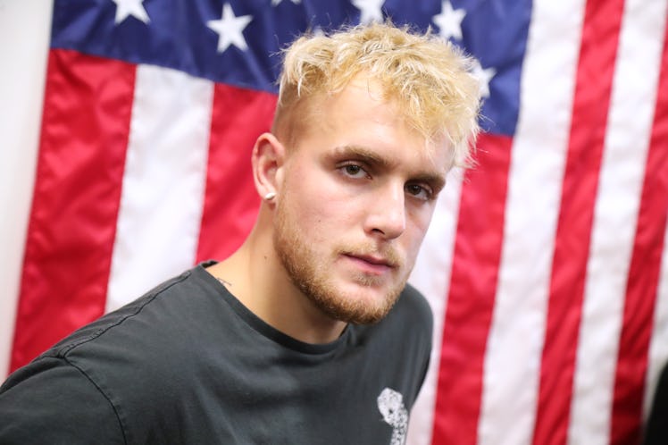 Jake Paul poses in front of an American Flag.