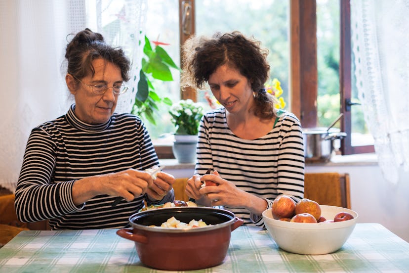 A mom and daughter making an apple pie. Body image issues can affect anyone over the holidays.