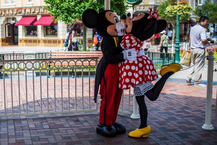 Mickey and Minnie Mouse share a kiss at Disneyland. 