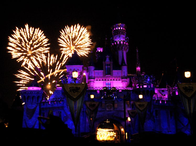 Fireworks fly into the sky behind Disneyland's Sleeping Beauty Castle. 
