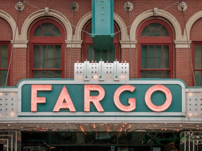 The sign of the Fargo Theatre in Fargo, North Dakota glows in pink and teal.