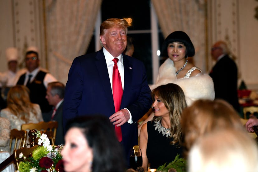 President Donald Trump and First Lady Melania Trump attend a Christmas dinner at the president's Mar...