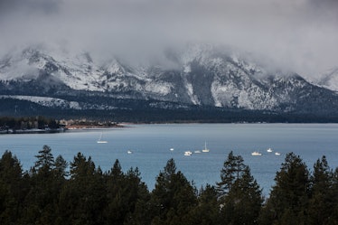 The snowy mountains looking over South Lake Tahoe are covered with a layer of fog. 
