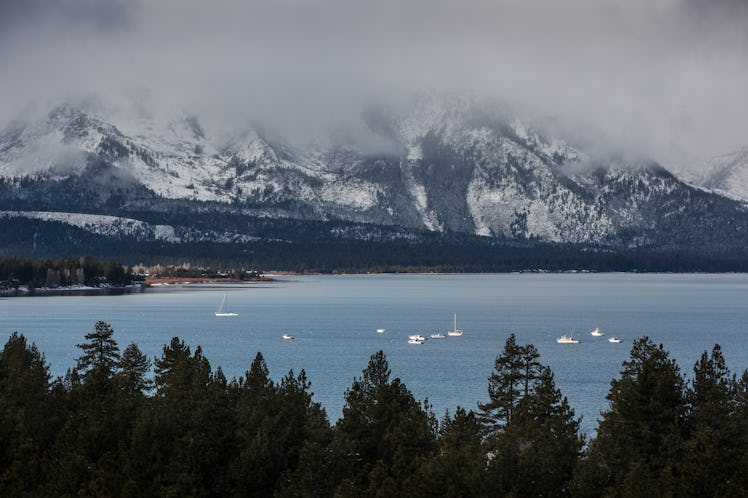 The snowy mountains looking over South Lake Tahoe are covered with a layer of fog. 