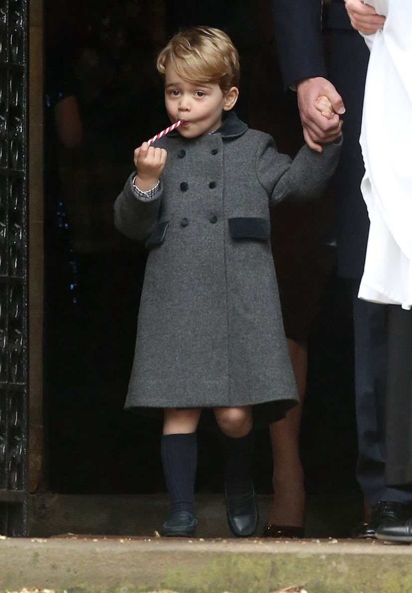 Prince George enjoys a candy cane after Christmas church services