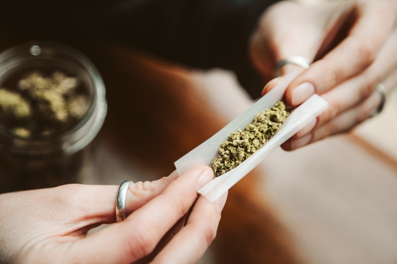 A woman rolls a joint. A doctor explains potential side effects of getting high, including what's be...