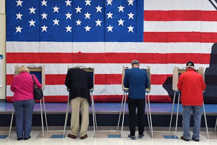 Four Georgia Republicans voting with their backs turned and the U.S. flag in front of them
