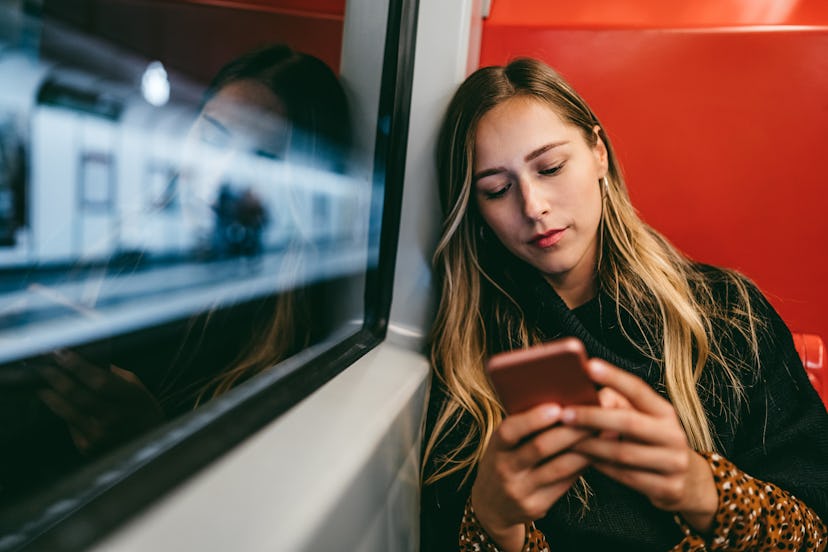 A person rides a train while looking at her smartphone. Instead of dopamine fasting, you should seek...