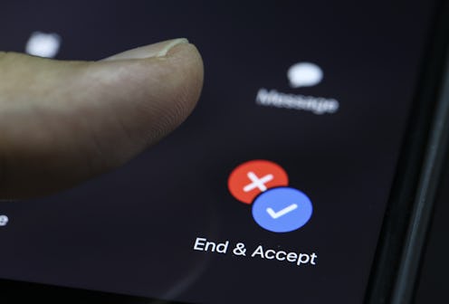Someone's thumb hovers over a smart phone prompting them to end or accept a call. Dopamine fasting m...