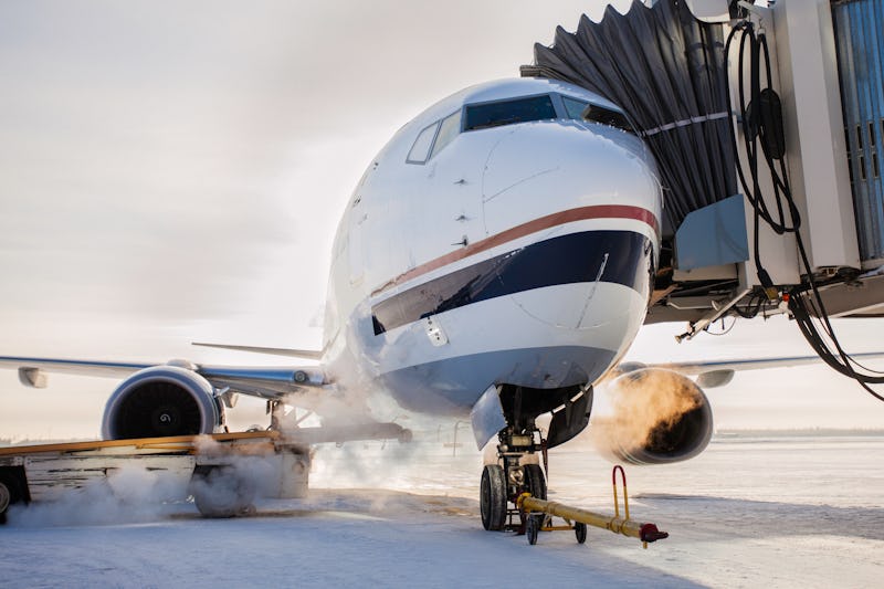 A plane sets up for a flight at a jetbridge. Carbon offsets are touted as a way to reduce the enviro...