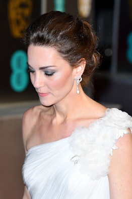 Kate Middleton with an updo, wearing a white bold, one-shoulder dress at the BAFTAs