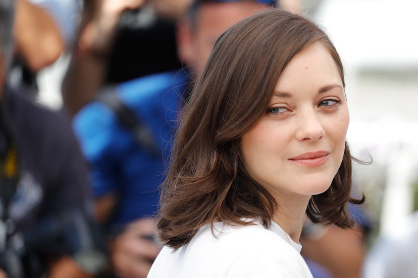 Marion Cotillard smiling while posing for a photo