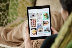 A person using a tablet with an opened PInterest website