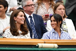 Meghan Markle & Kate Middleton sitting next to each other at a tennis match