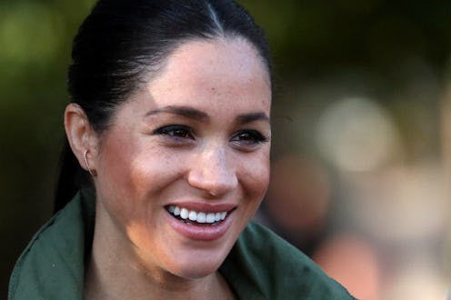 Full-profiled Meghan Markle smiling