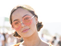 A girl wearing space buns as a part of festival hair trends for 2019 on a summer festival