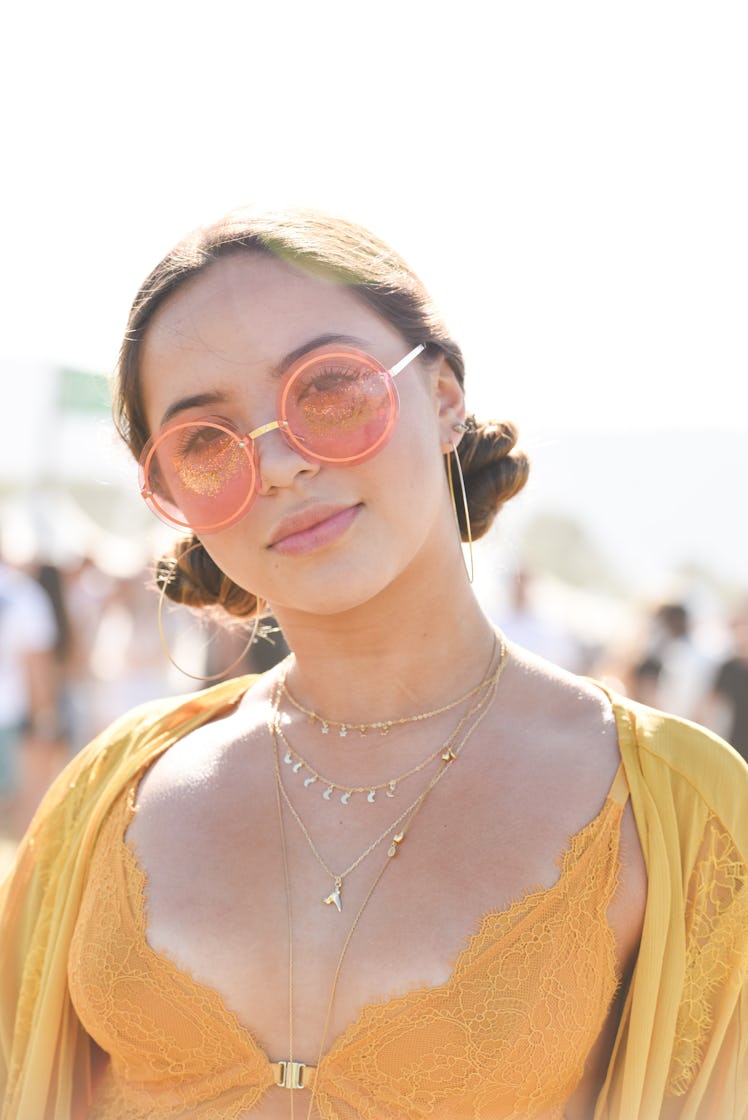 A girl wearing space buns as a part of festival hair trends for 2019 on a summer festival