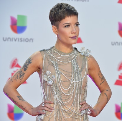Halsey posing for a photo in a grey see-through gown