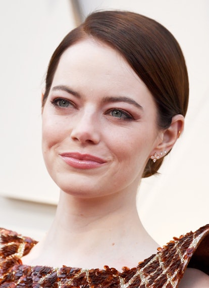 Emma Stone wearing a copper eyeshadow and a classic updo for the red carpet