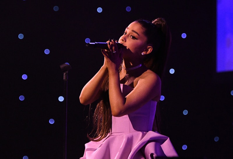 Ariana Grande in a pink dress during her performance