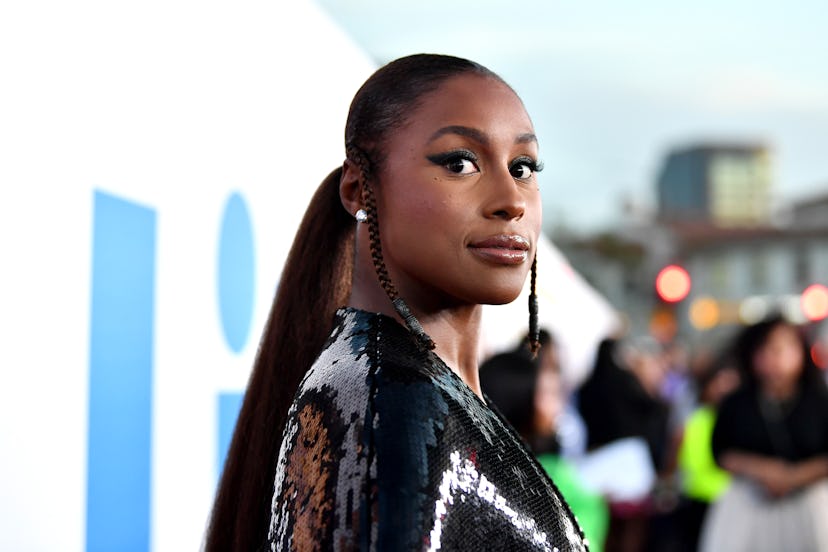 Issa Rae, with a neat, sleek ponytail with subtle braided tendrils